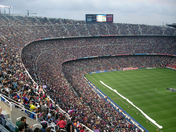 Packed soccer stadium with enthusiastic fans cheering on matchday